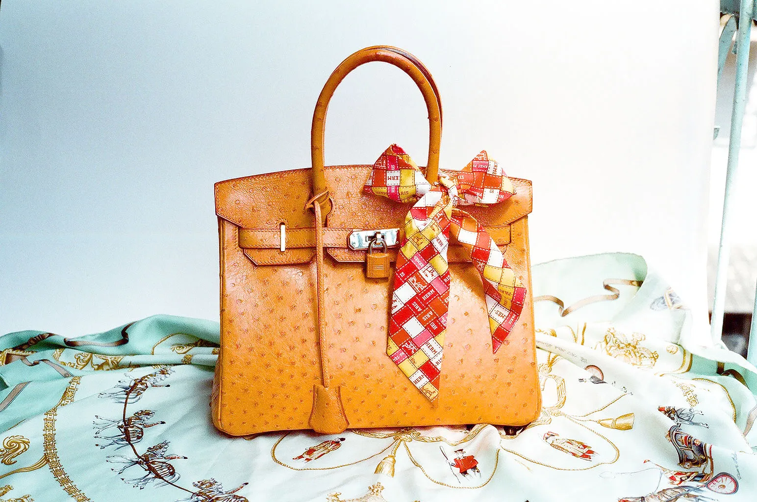 Hermès Birkin bag in orange ostrich leather with palladium hardware and silk twilly scarf