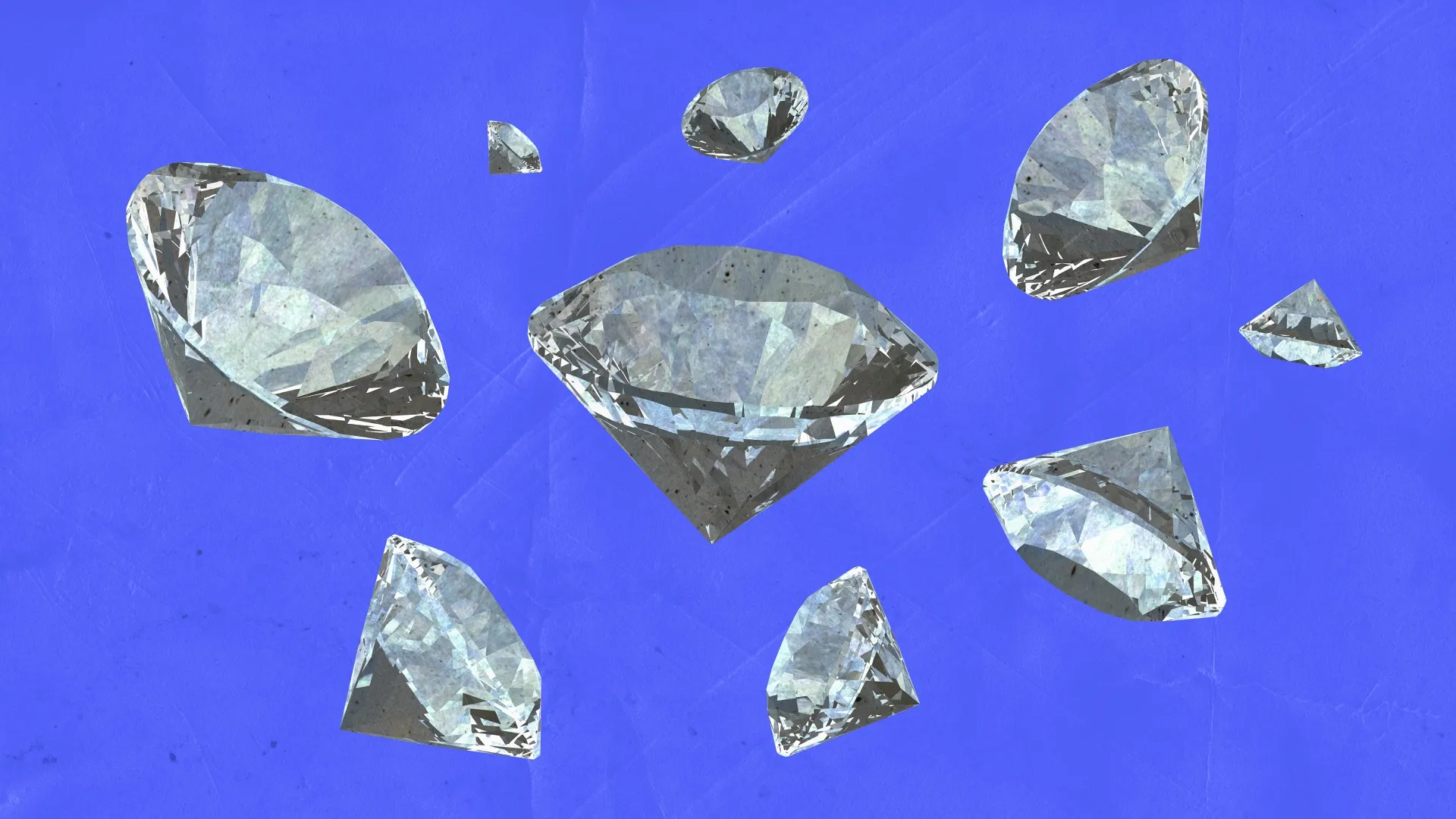 Collection of loose diamonds in various sizes displayed on blue background