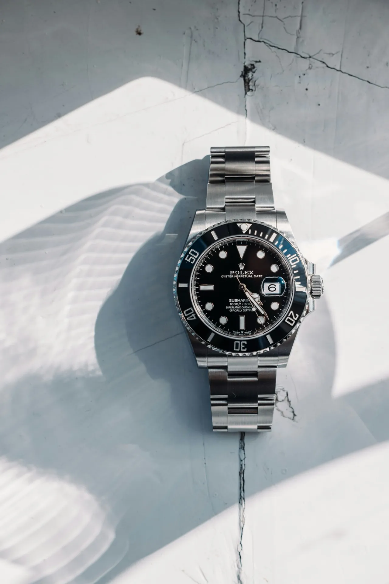 Stainless steel Rolex Submariner with black dial photographed in natural light