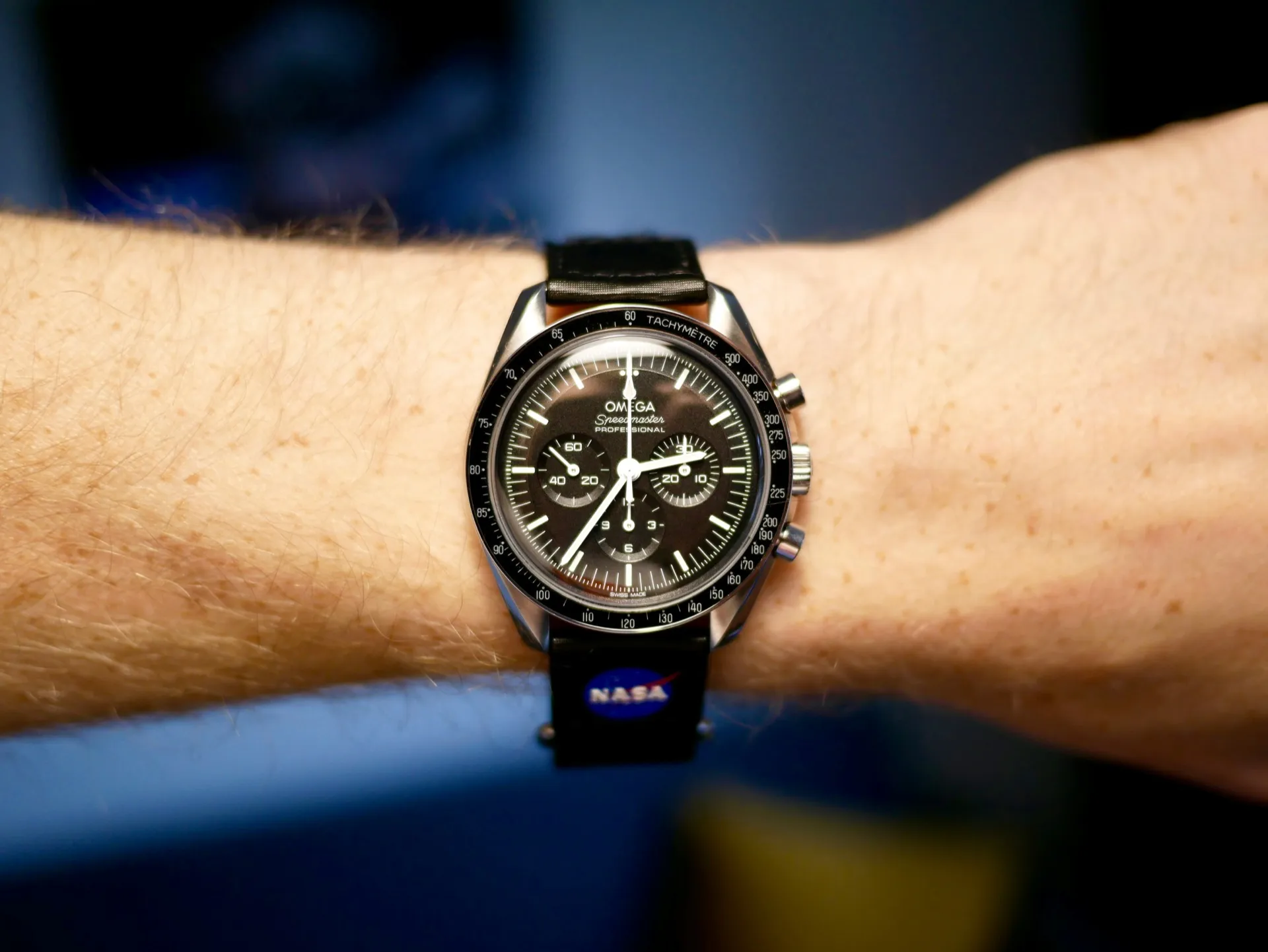 Omega Speedmaster on NASA-branded NATO strap worn on wrist