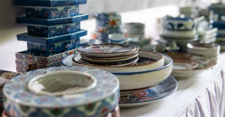 Collection of Japanese and Chinese porcelain plates, bowls, and tiered boxes in blue and white patterns