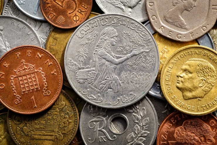 Assorted international coins from various countries filling the frame